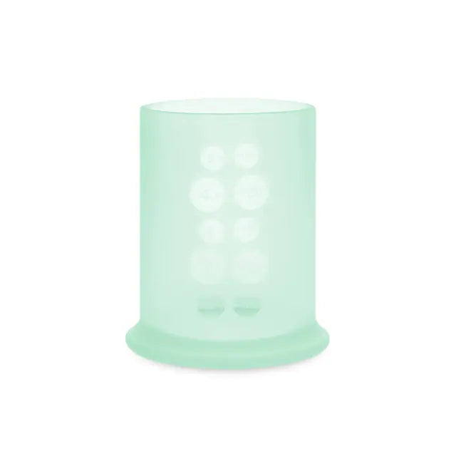 A mint Olababy Silicone Training Cup on white, with the grip bumps moulded into the far wall showing through the front of the cup.